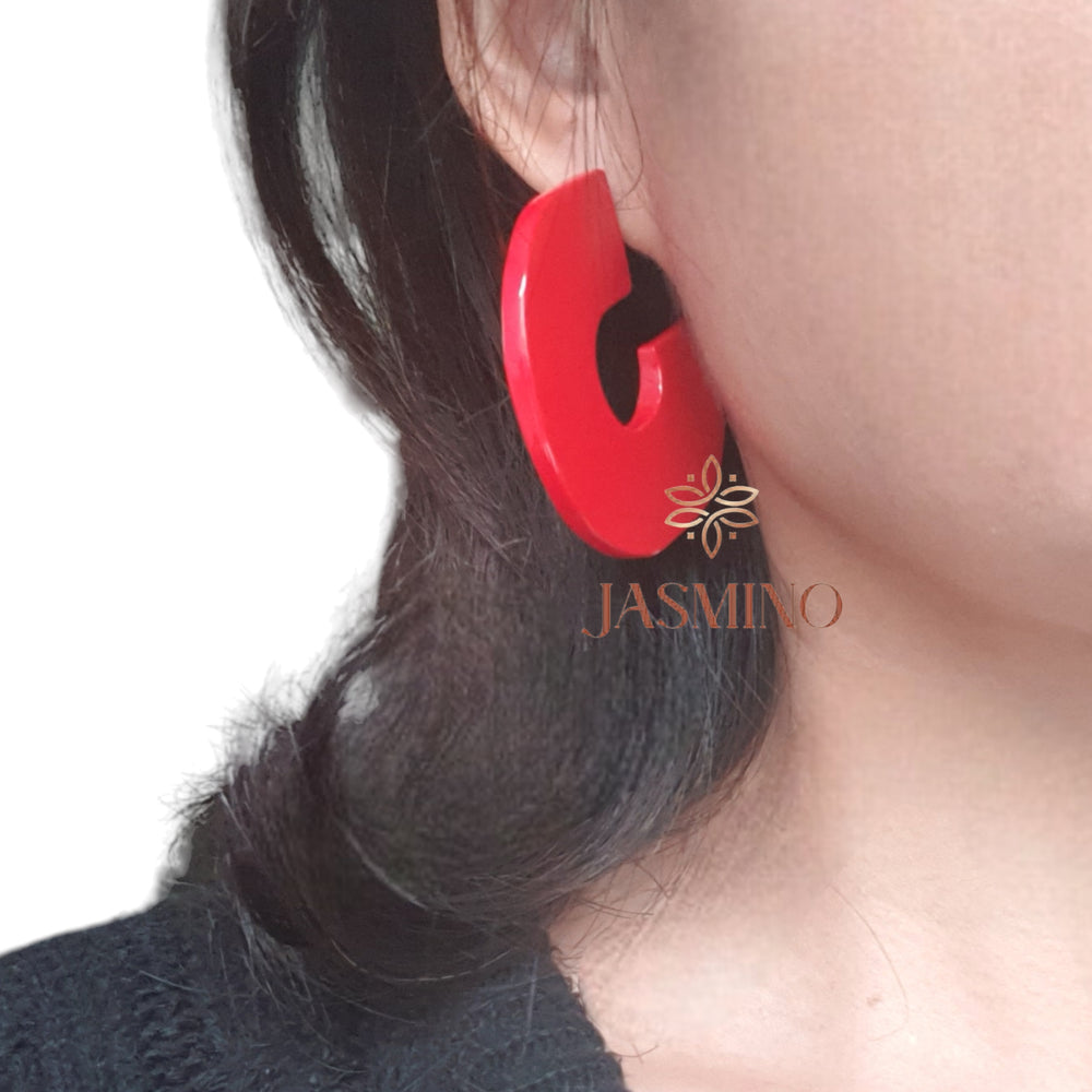 
                  
                    handmade C shaped stud earrings feature scarlet red in natural buffalo horn for Spring 2024
                  
                