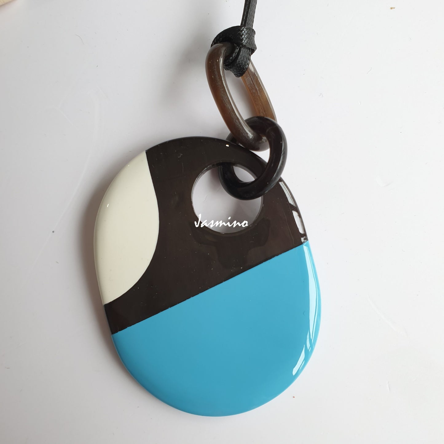 Jasmino unique handmade turquoise pendant features an oval shape in natural buffalo horn