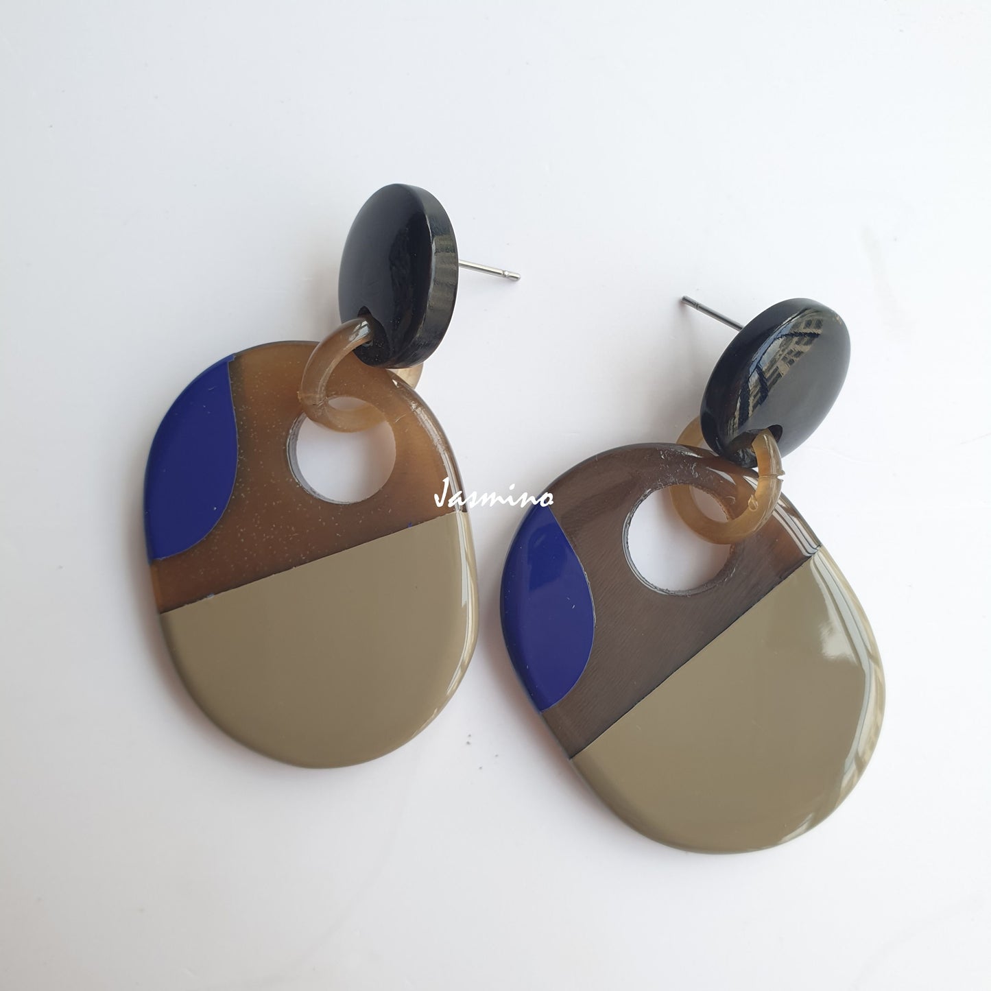 Handmade stainless steel earrings are crafted by professional Vietnamese craftsman with dark colors in the natural light