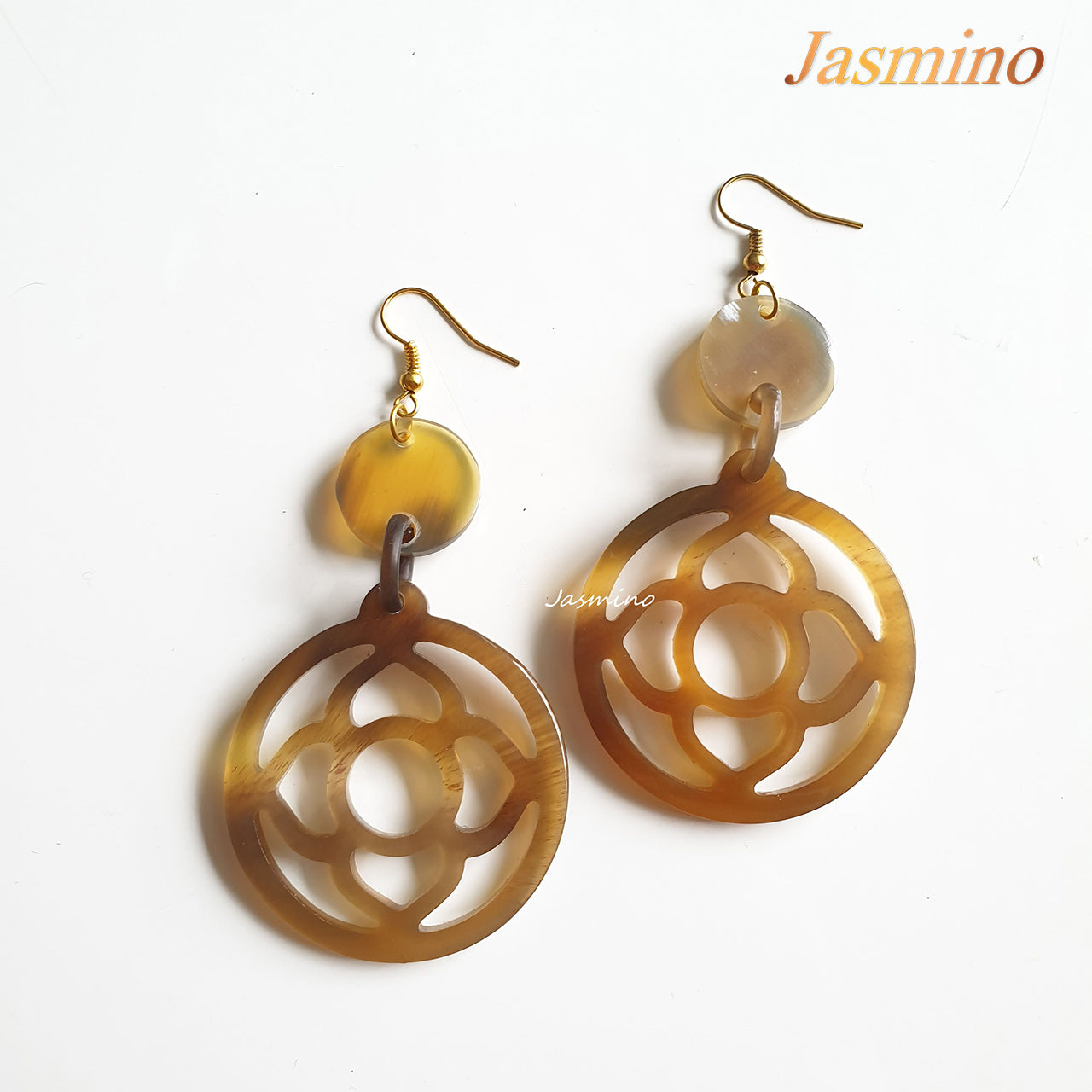 Unique handmade round shape natural horn earrings on the light background, unique gift for your friend