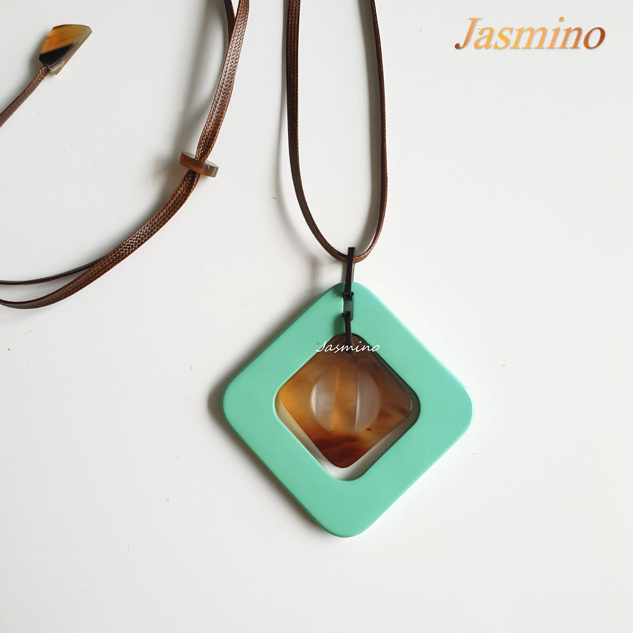 mint rhombus pendant on the light background, impressive gift for her