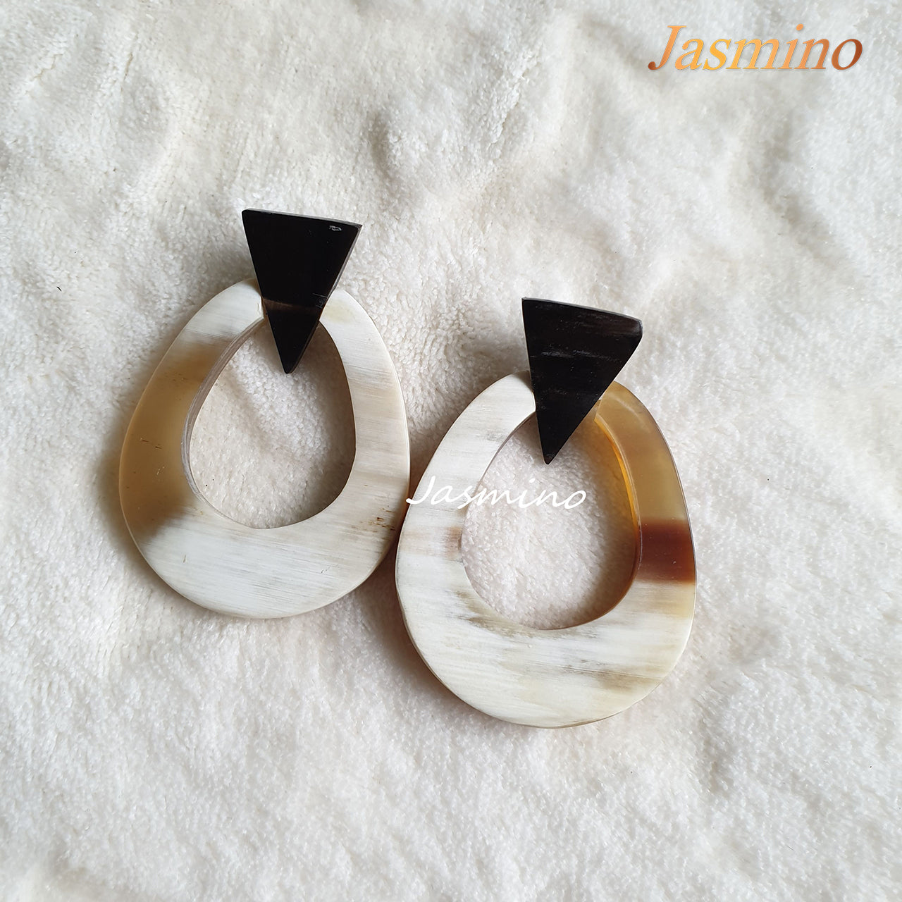 Handmade oval earrings are made of natural buffalo horn with an ombre color in the natural light