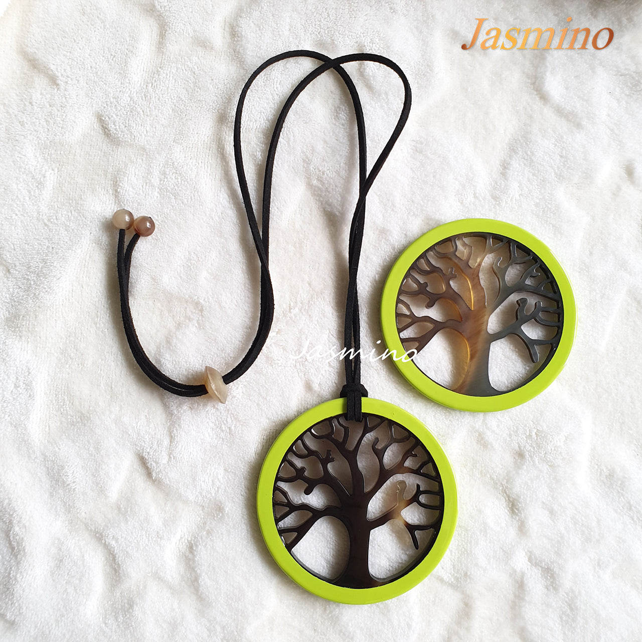 Two circular pendants are designed with lime outline, inside with a tree pattern made of unique natural buffalo horn on a light background, impressive gift for her