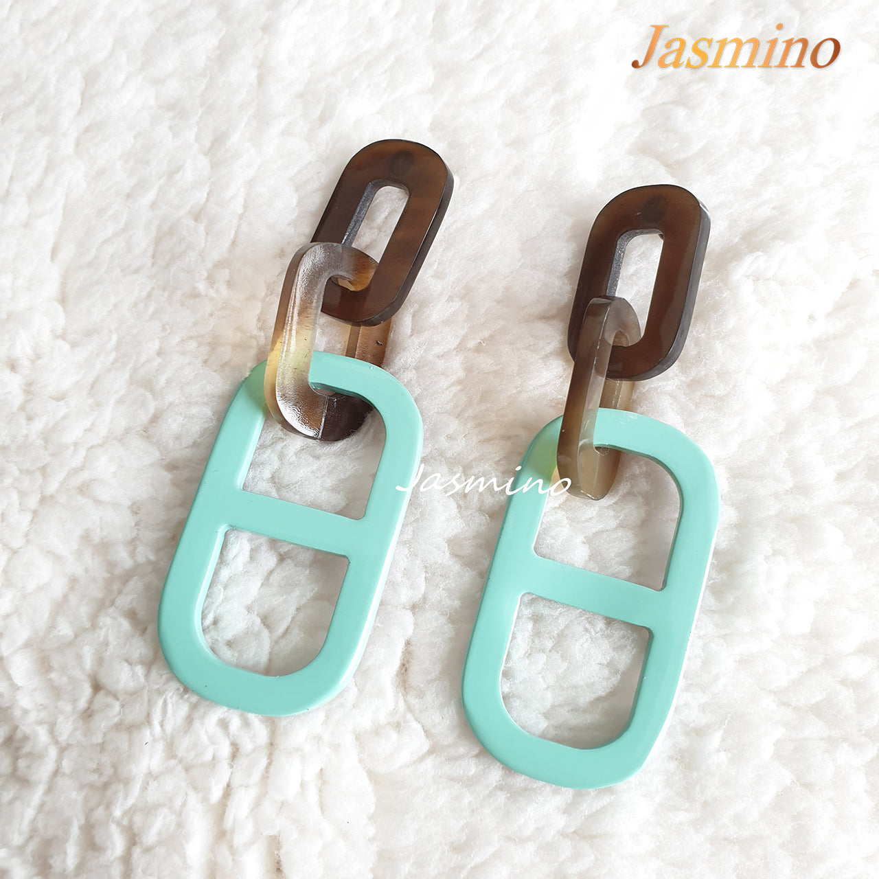 Jasmino unique handmade earrings feature a paperclip shape with turquoise and brown color made of natural buffalo horn