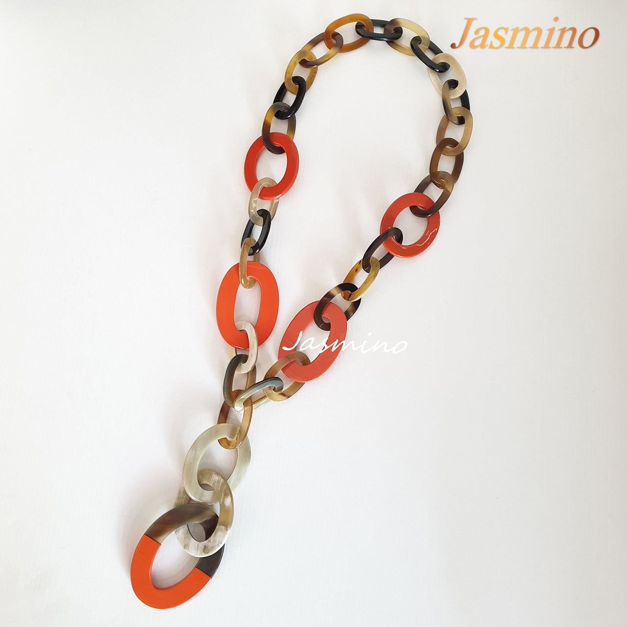 The necklace has several large orange peel pieces in natural light, impressive gift for her