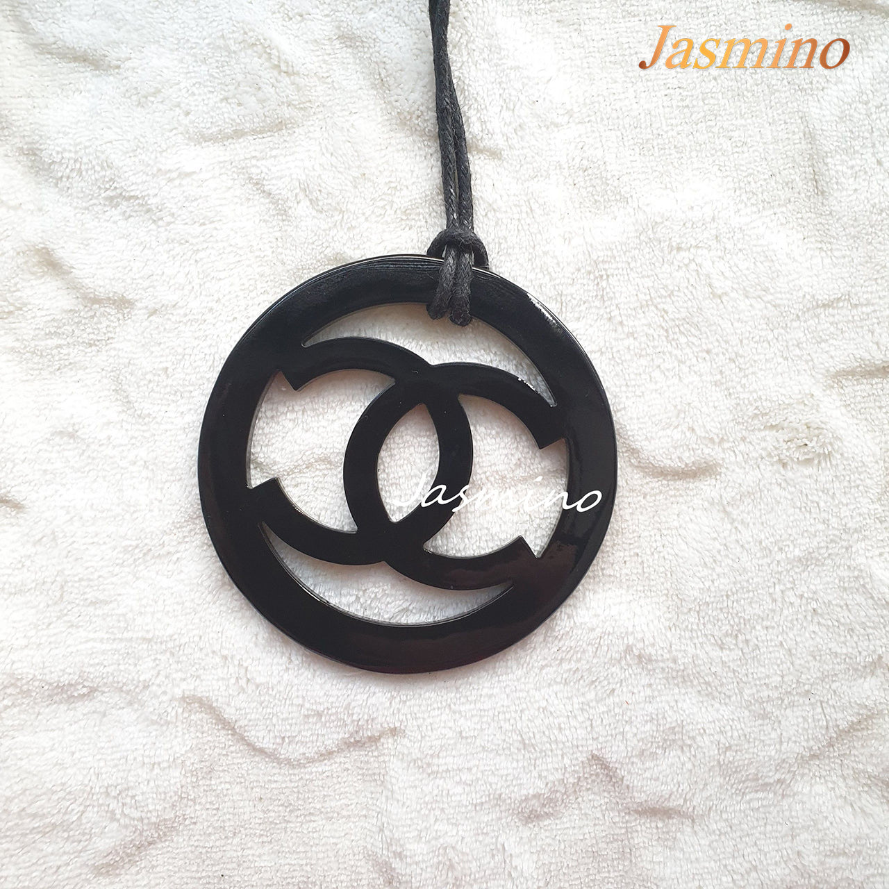 black pendant with Chanel symbol in natural light, unique gift for your friend