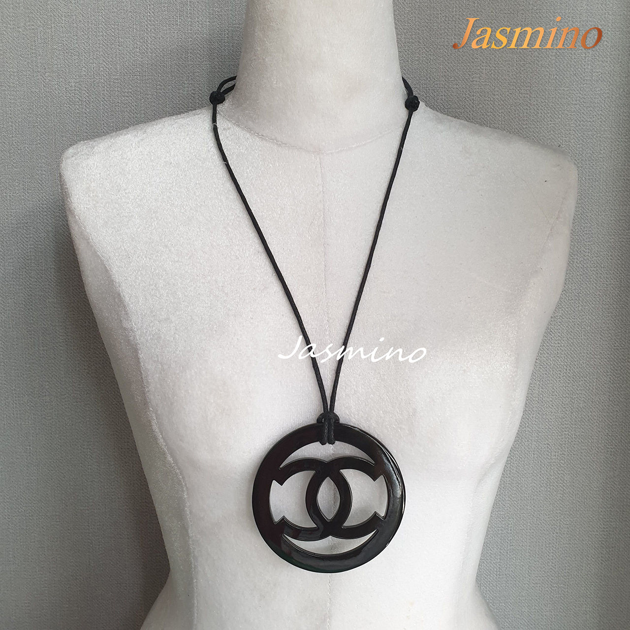 black pendant with Chanel symbol in natural light, unique gift for your friend