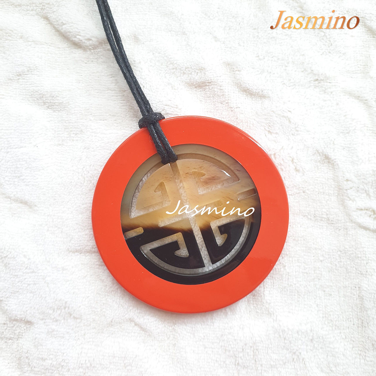 orange red lacquer pendant on the light background, impressive gift for her