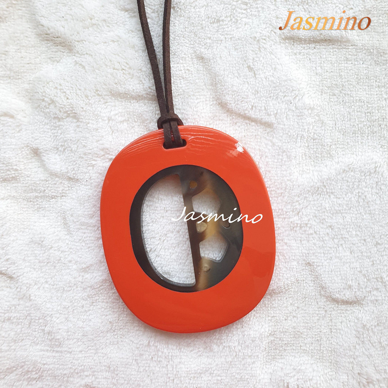 elliptical orange peel horn pendant on the light background, impressive gift for her