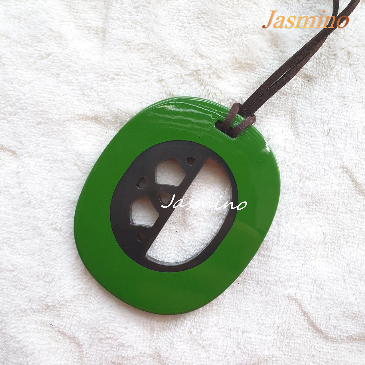 elliptical green horn pendant on the light background, impressive Christmas gift for her