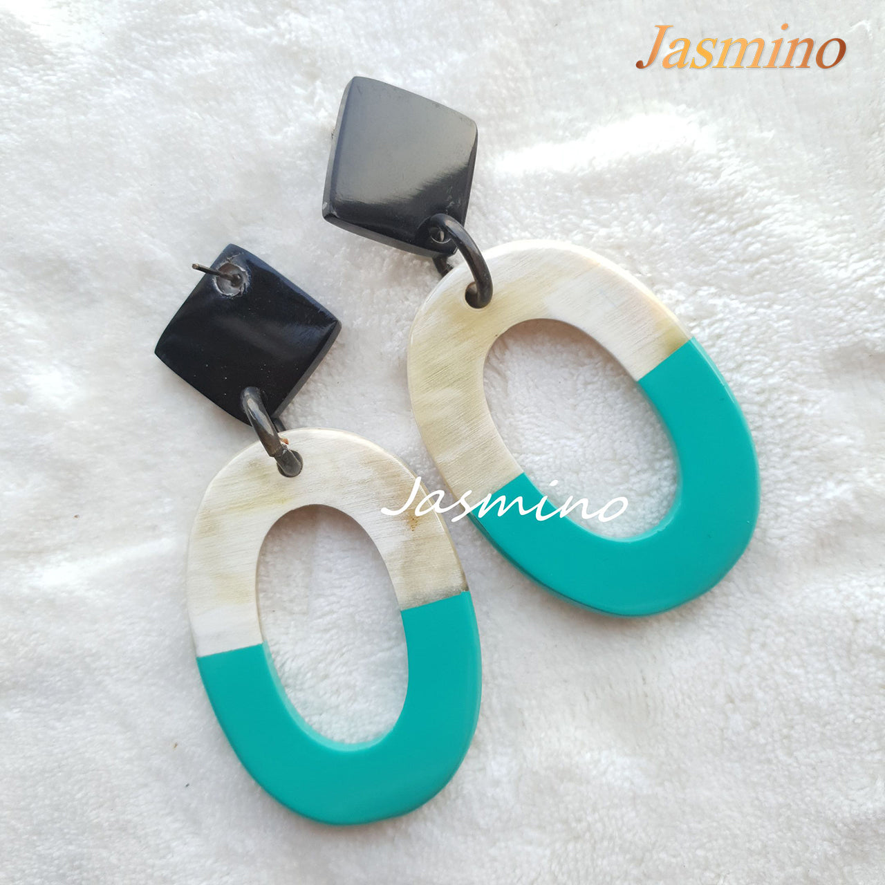 Handmade large oval drop earrings feature turquoise and white in the natural light