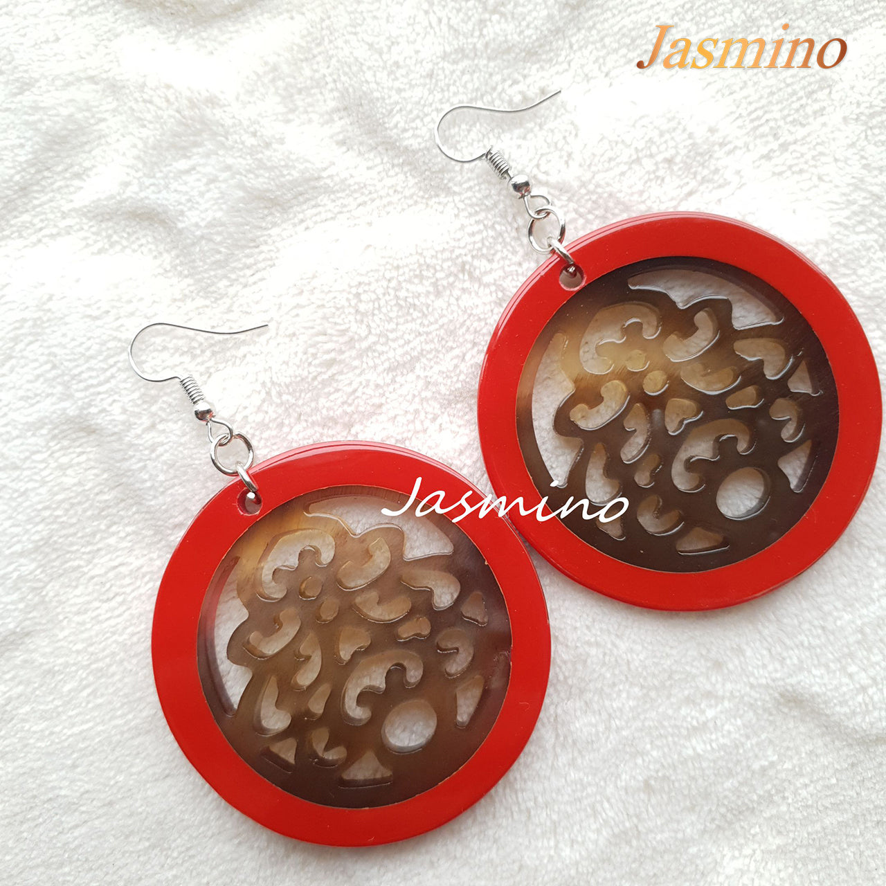 Beautiful unique floral circle dangle earrings feature red and brown in the natural light