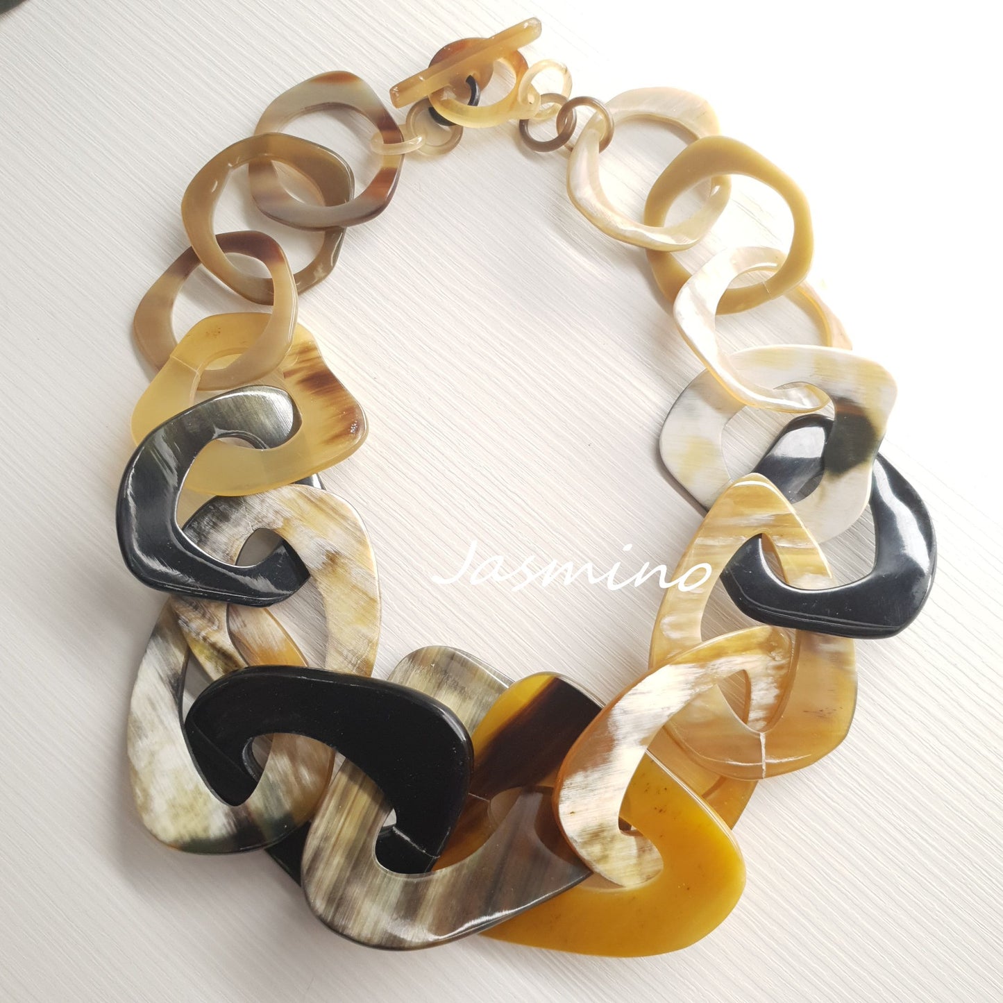 rustic natural buffalo horn necklace on the light background - 50cm