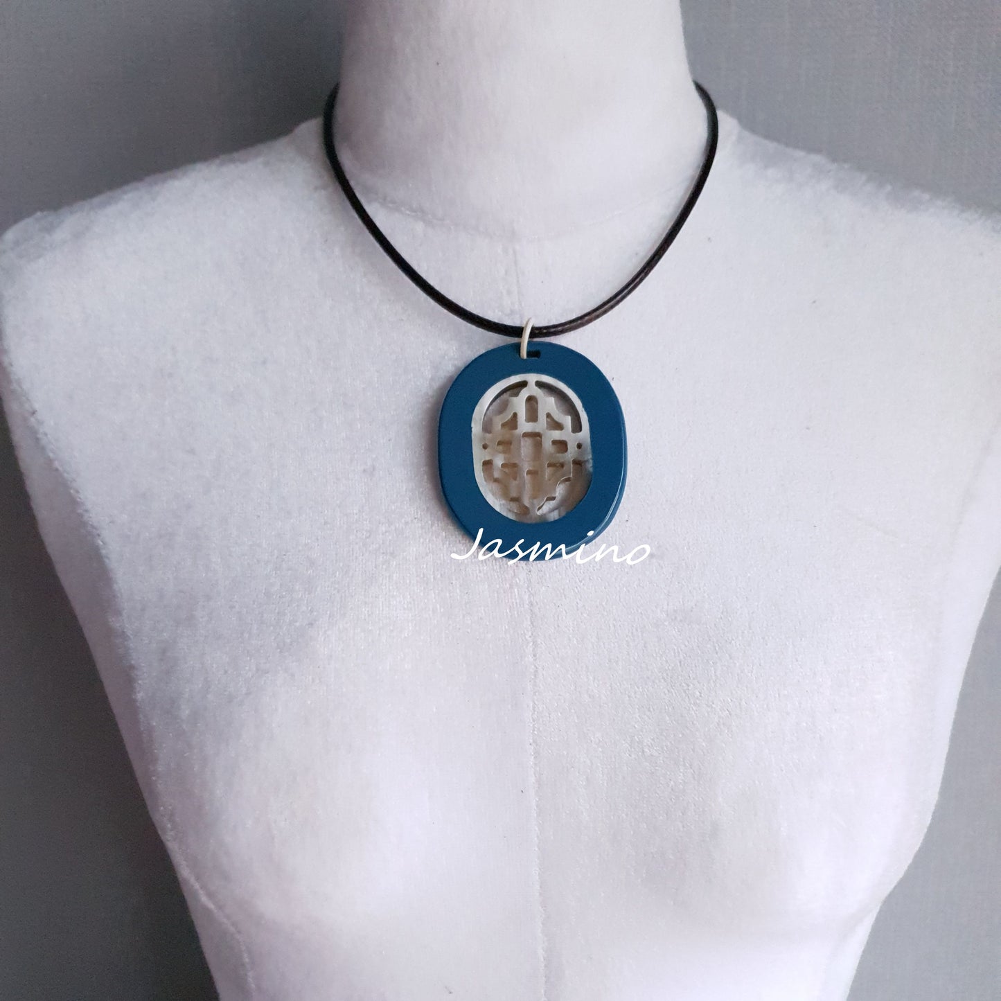 elliptical royal blue necklace on the light background, impressive gift for her