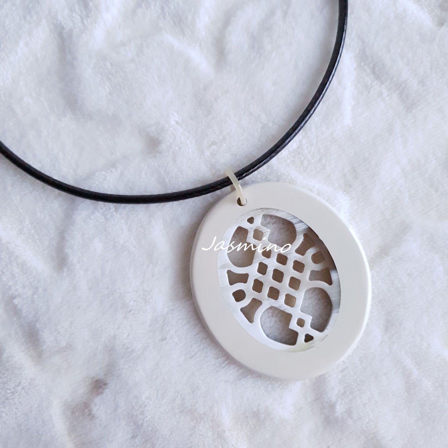 elliptical cream white horn necklace on the light background, impressive gift for her