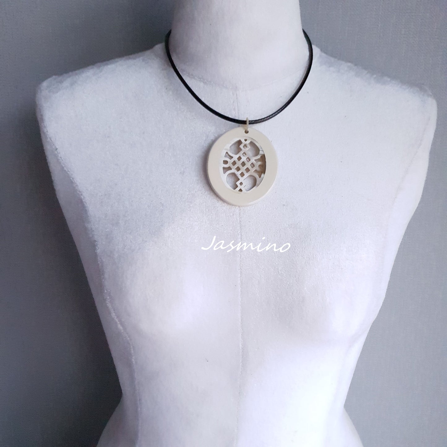 elliptical cream white horn necklace on the light background, impressive gift for her