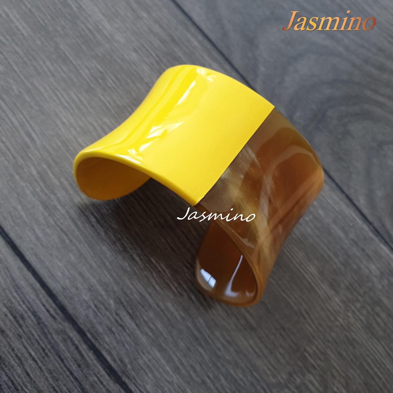  Handmade bright yellow cuff bracelet on a grey table for a unique gift