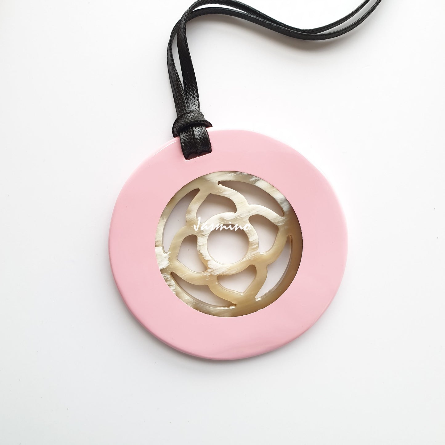 <img src = "buffalo horn pendant.jpg" alt = "round pendant with light pink outside, inside with flower pattern made from natural buffalo horn on a light background, an impressive gift for her">