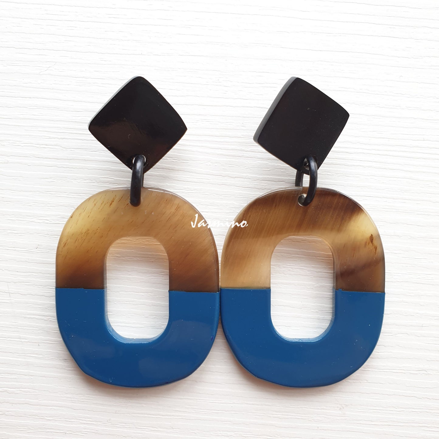 Handmade oval earrings feature navy blue made by natural buffalo horn for women on a white background