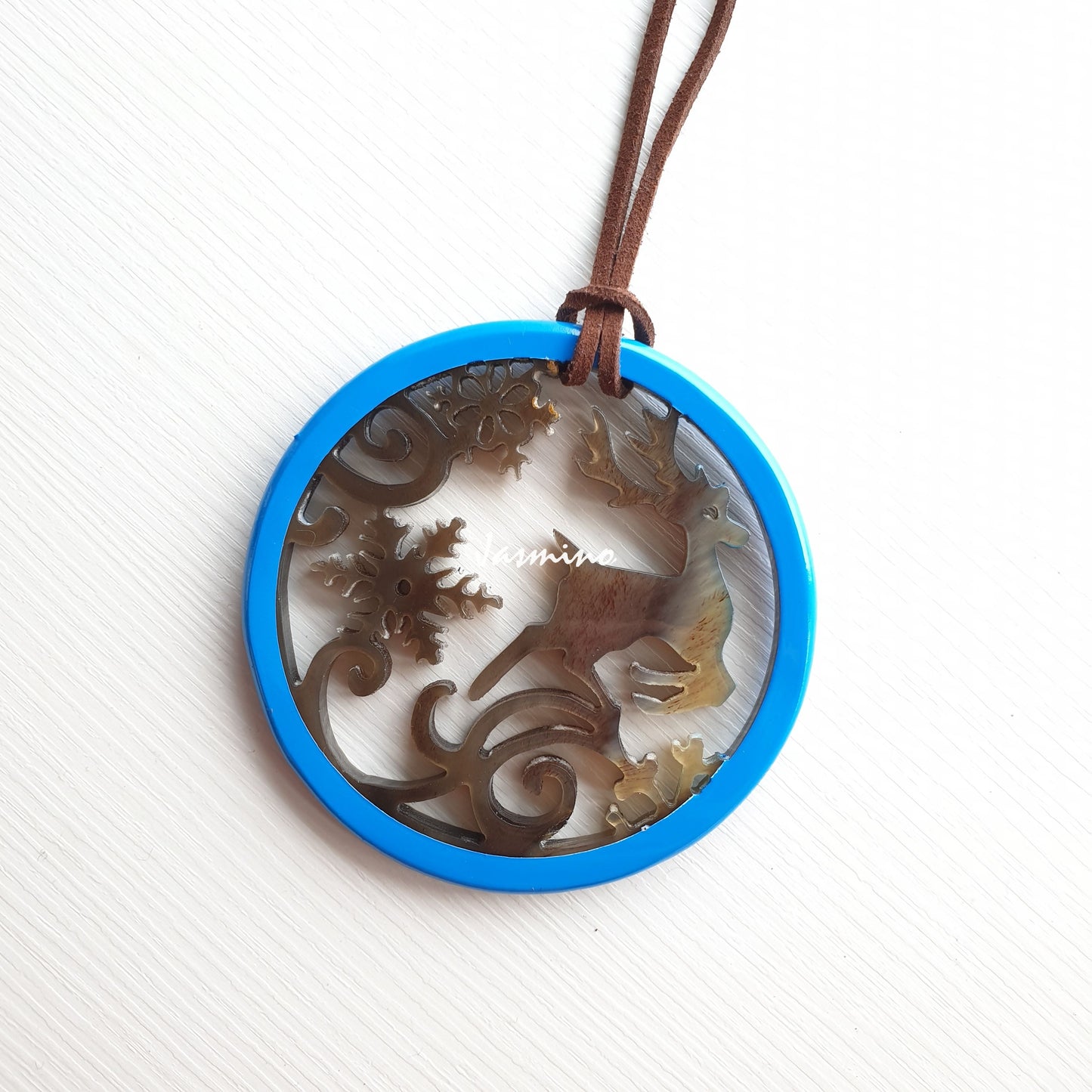 round sky blue pendant with unique pattern on the light background, impressive gift for your friend