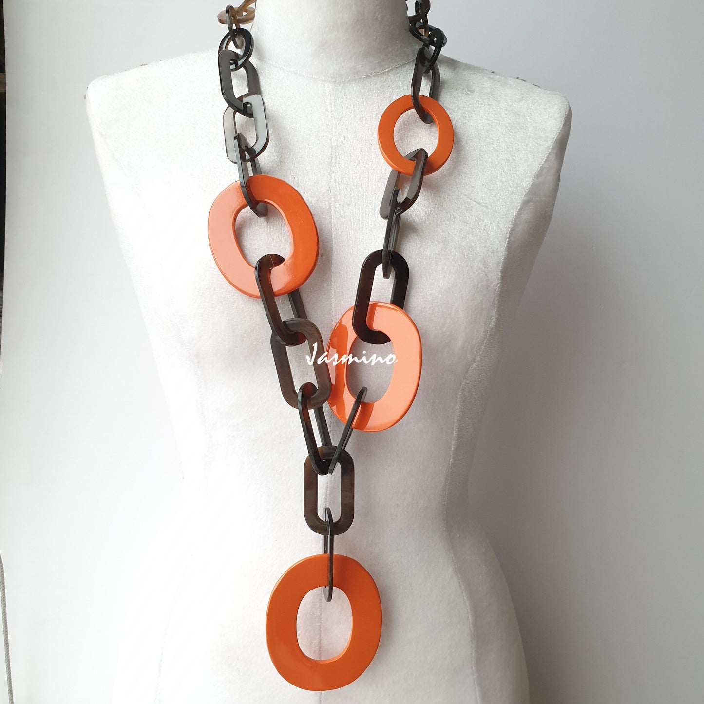 The necklace has several large orange peel pieces in natural light, impressive gift for her