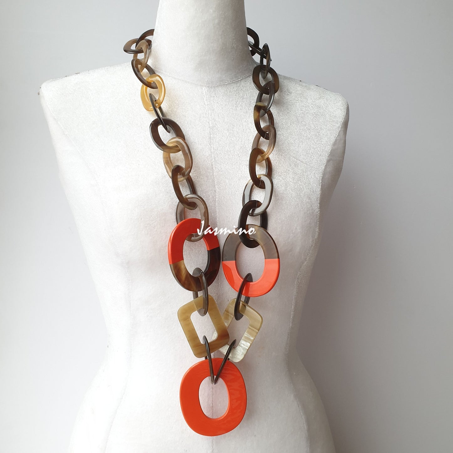 The necklace has several large orange peel pieces in natural light, impressive gift for her