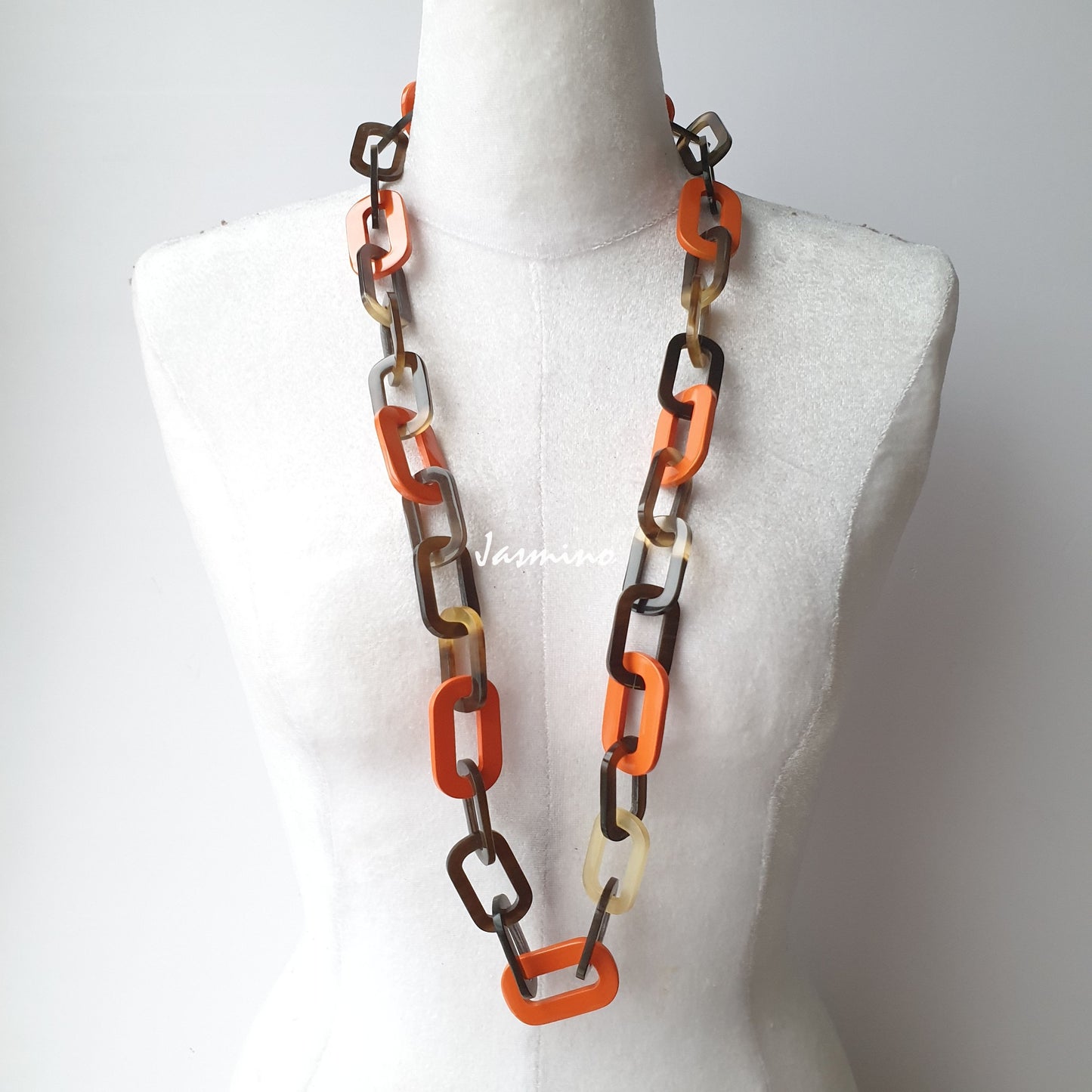 The necklace has several orange peel pieces in natural light, impressive gift for her