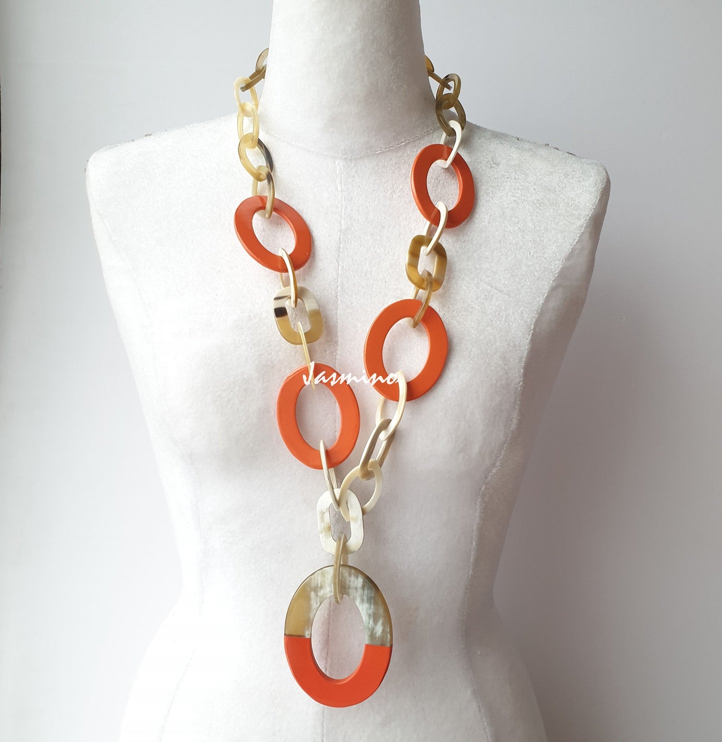 The necklace has several large orange peel pieces in natural light, impressive gift for her