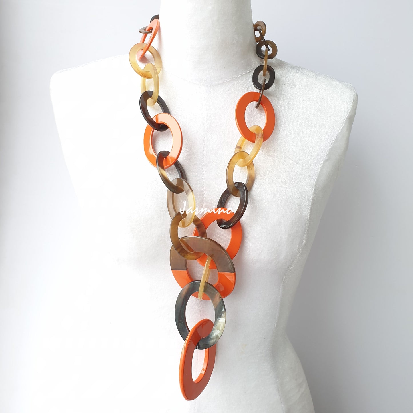 The necklace has several orange peel pieces in natural light, impressive gift for her