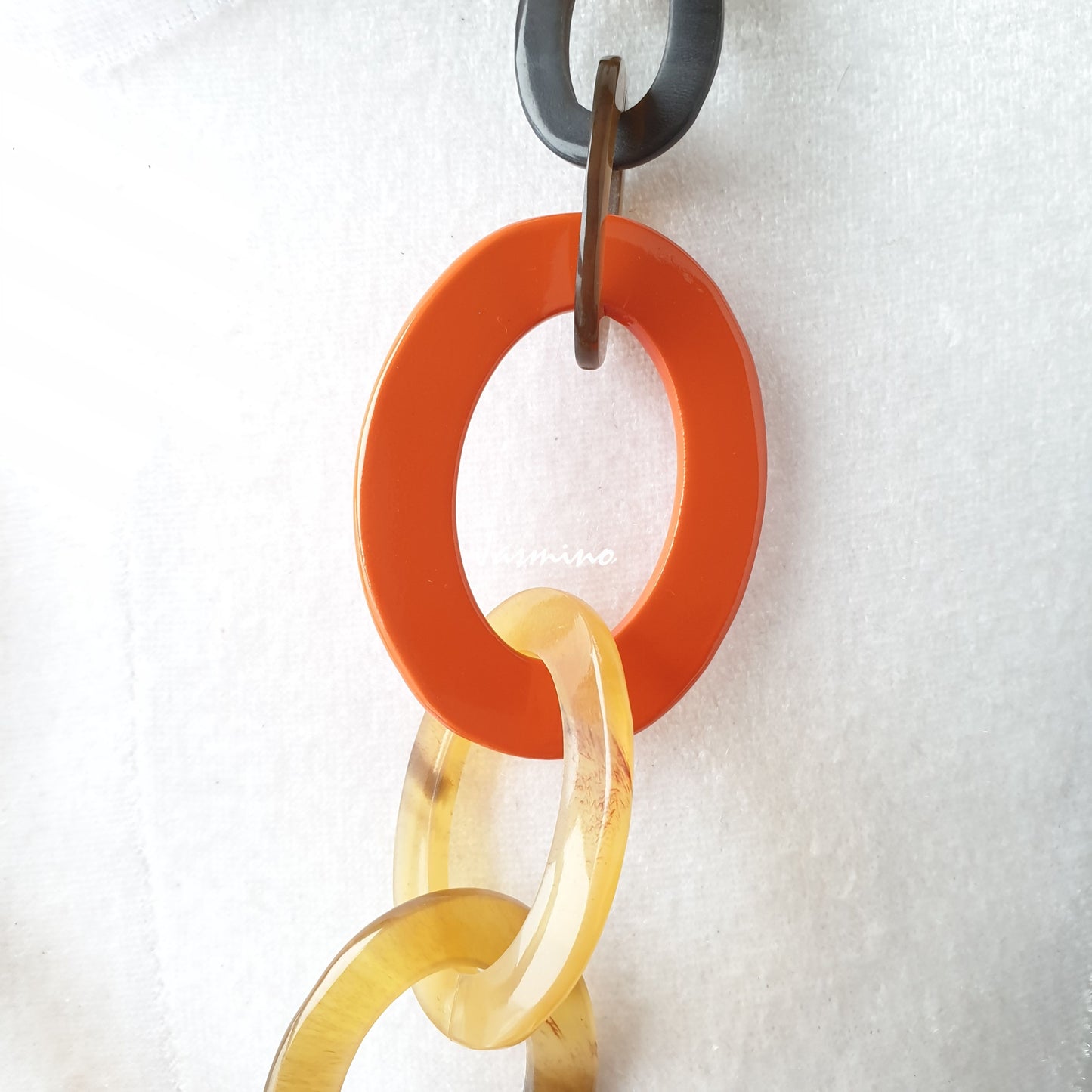 The necklace has several orange peel pieces in natural light, impressive gift for her