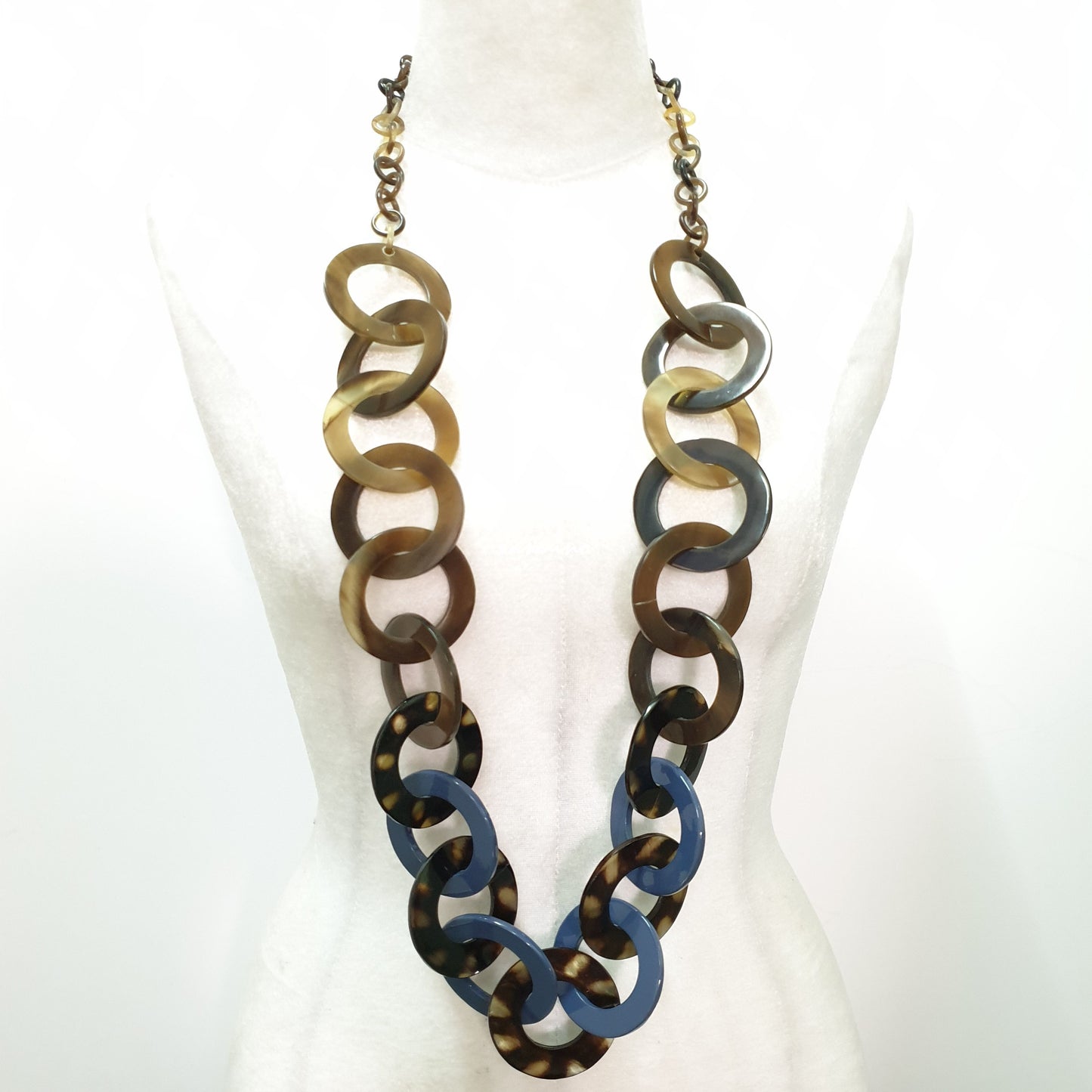 blue necklace made from a series of lacquered circular horn links on a light background, an impressive gift for her