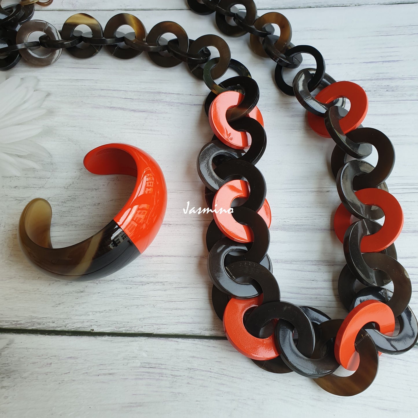 A set of unique handmade Bohemian large chain link necklace and cuff bracelet accessory features black and orange in natural buffalo horn for women's gifts