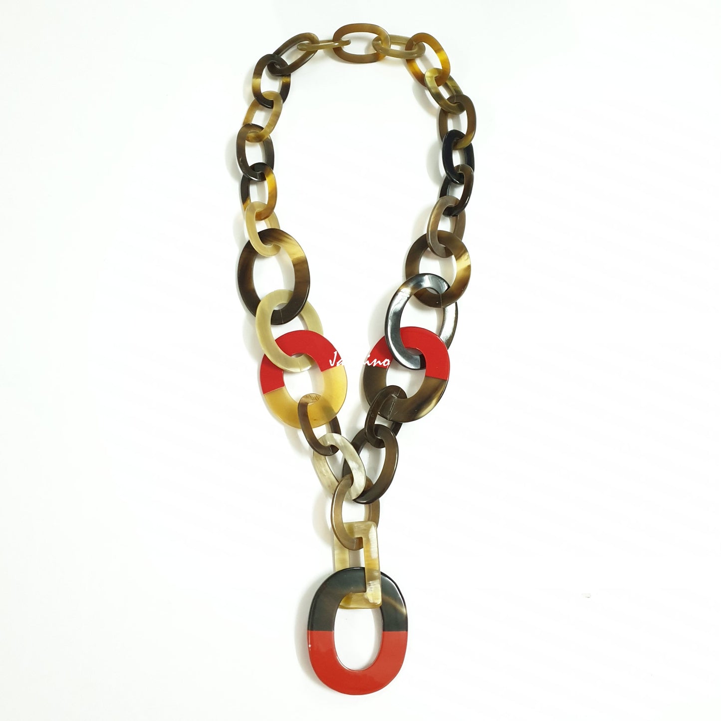 <img src="buffalo horn necklace.jpg" alt="The necklace has large pieces with half natural horn and half red lacquer in the natural light, unique gift for her">