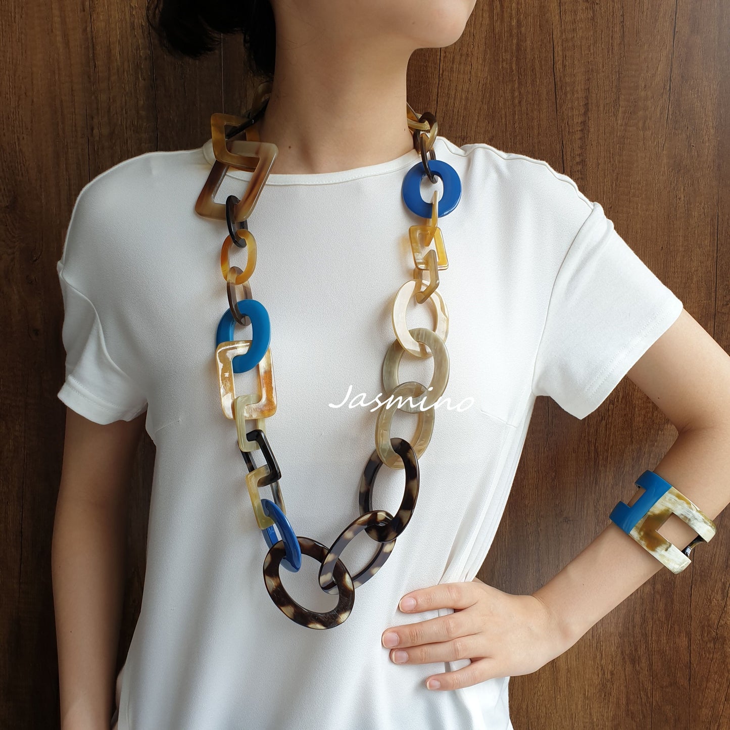 A model is wearing unique handmade circle rectangle necklace jewelry featured black and blue in natural buffalo horn 