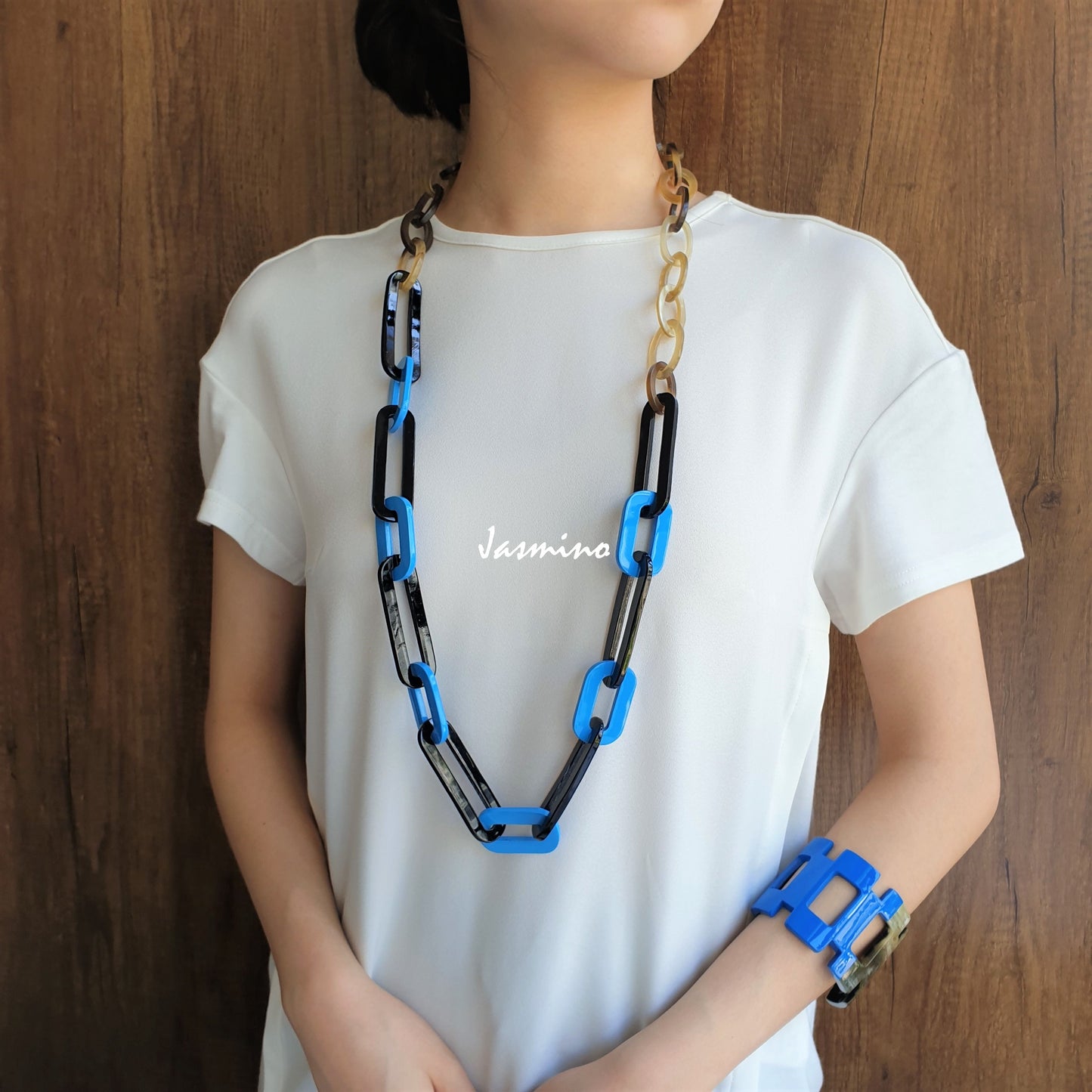 A model is wearing Jasmino unique handmade chain link necklace jewelry accessory featured black and blue in natural buffalo horn for women