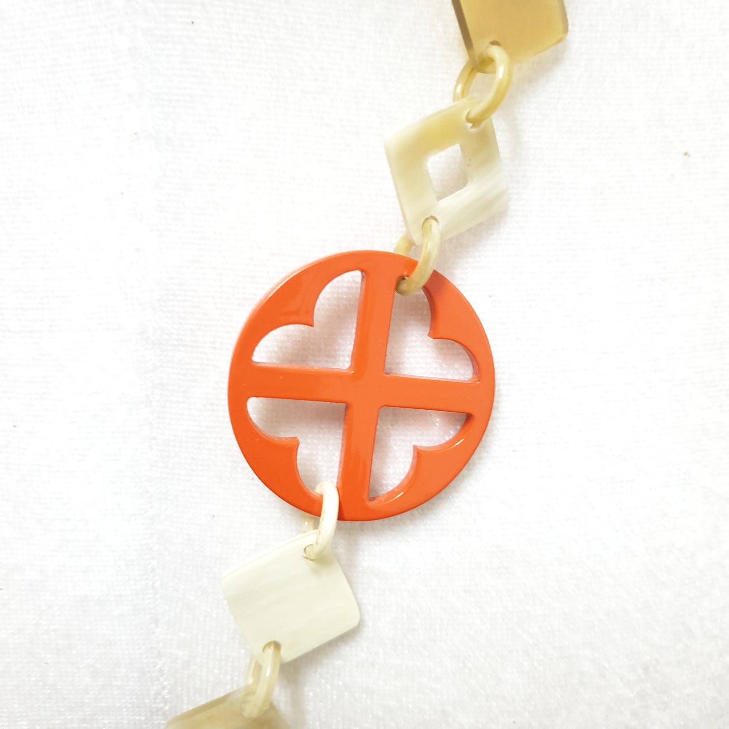 This necklace has some large orange pieces with different patterns on the light background, unique gift for your friend