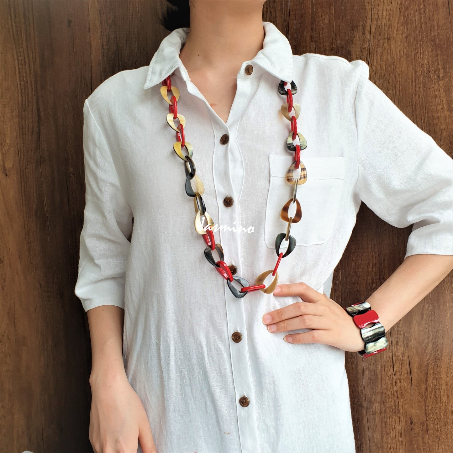 A model is wearing unique handmade necklace featured some red teardrop-shaped pieces in natural light, an impressive gift for her