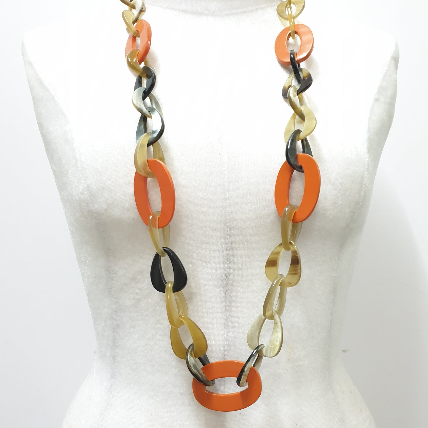 The necklace has several large orange peel pieces in natural light, impressive gift for her