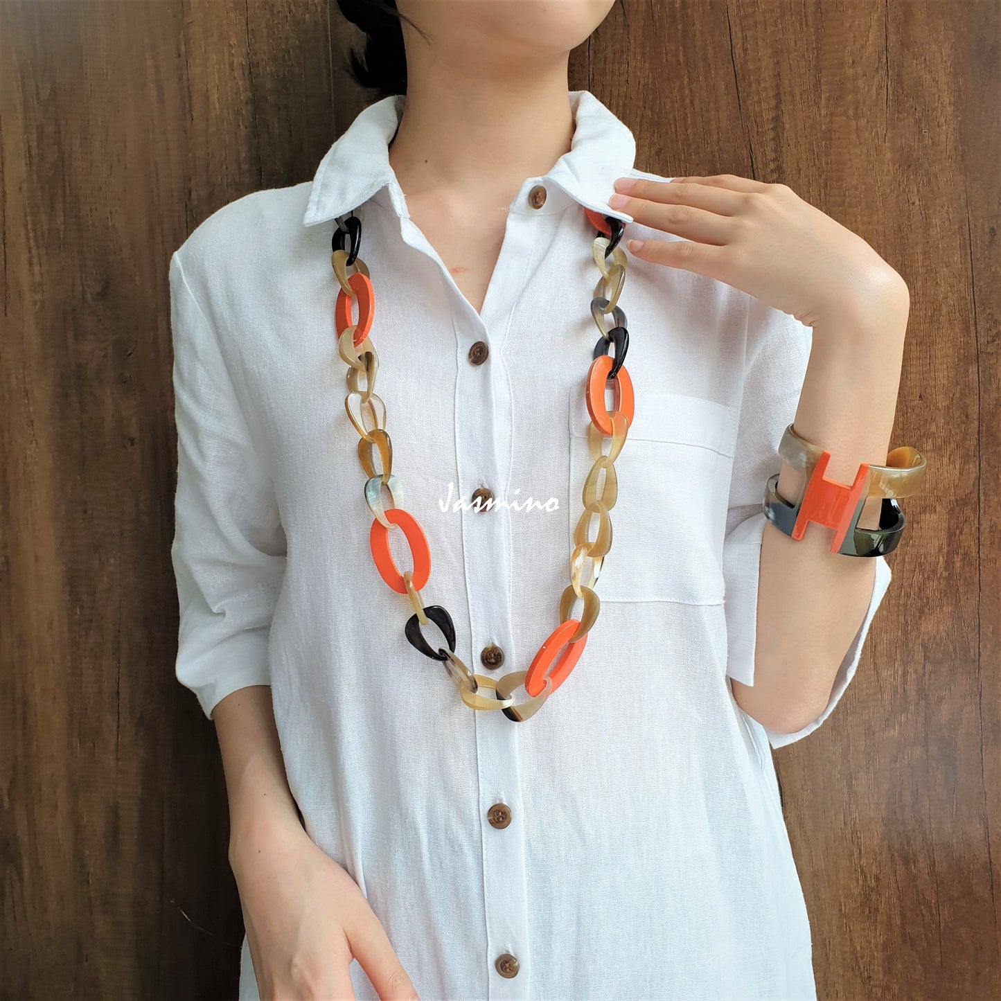 A model is wearing unique handmade necklace featured several large orange peel pieces in natural light, impressive gift for her