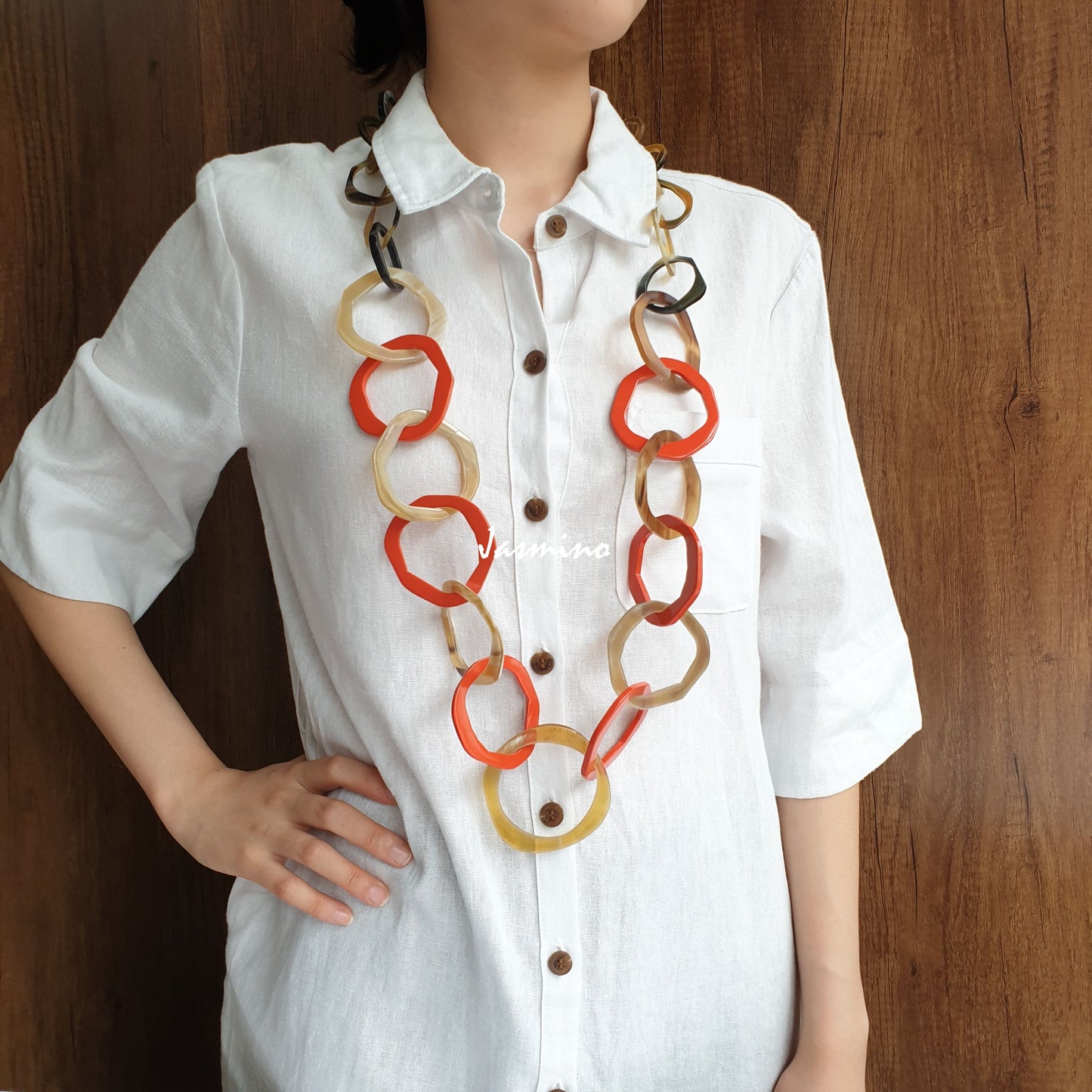 A model is wearing Jasmino unique handmade Minimalist Vintage geometric circle chain link necklace featured brown and orange in natural buffalo horn on Thanksgiving