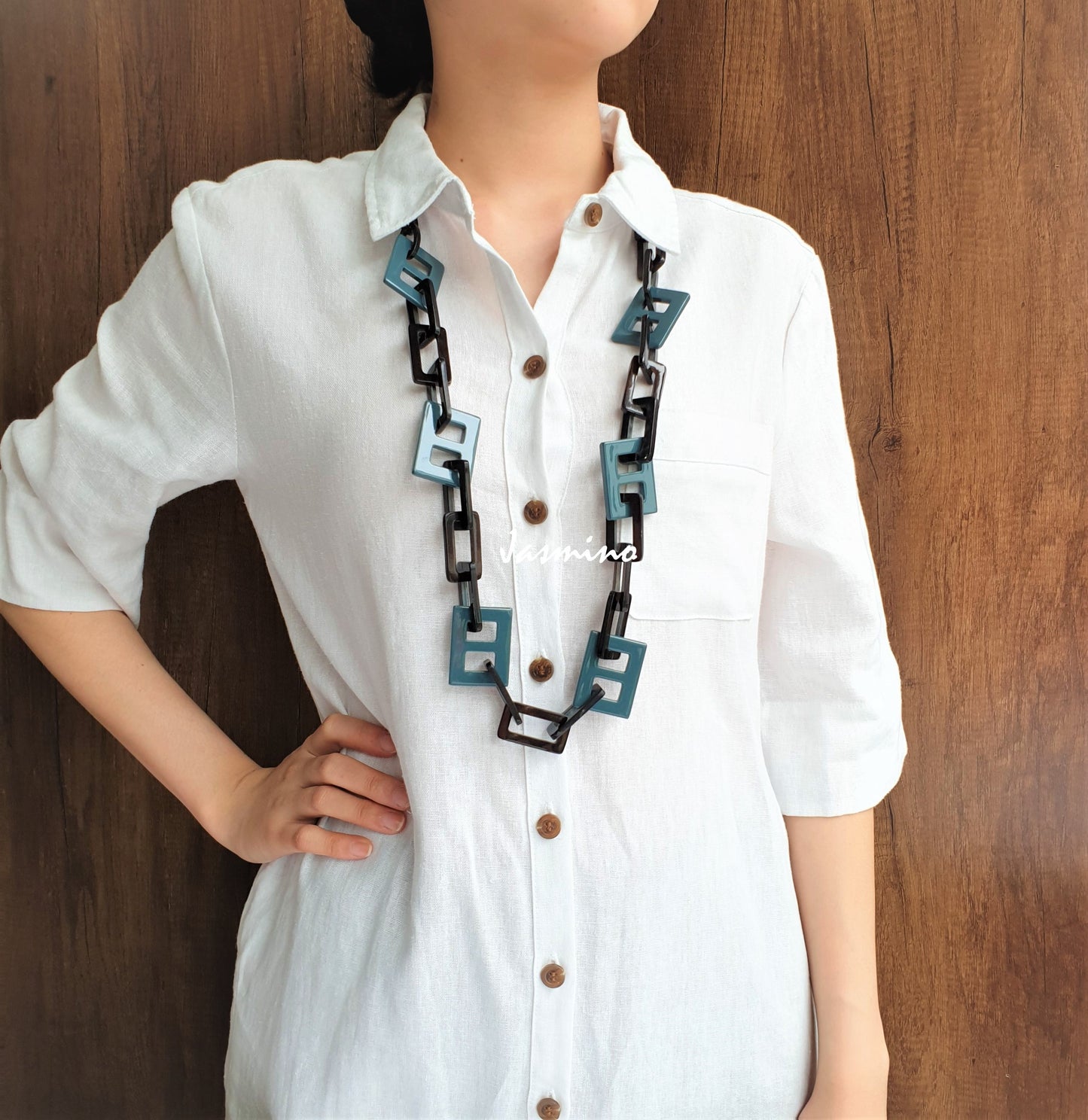 A model is wearing Jasmino unique handmade Vintage D-shaped rectangle chain link necklace featured greyish blue in natural buffalo horn for women