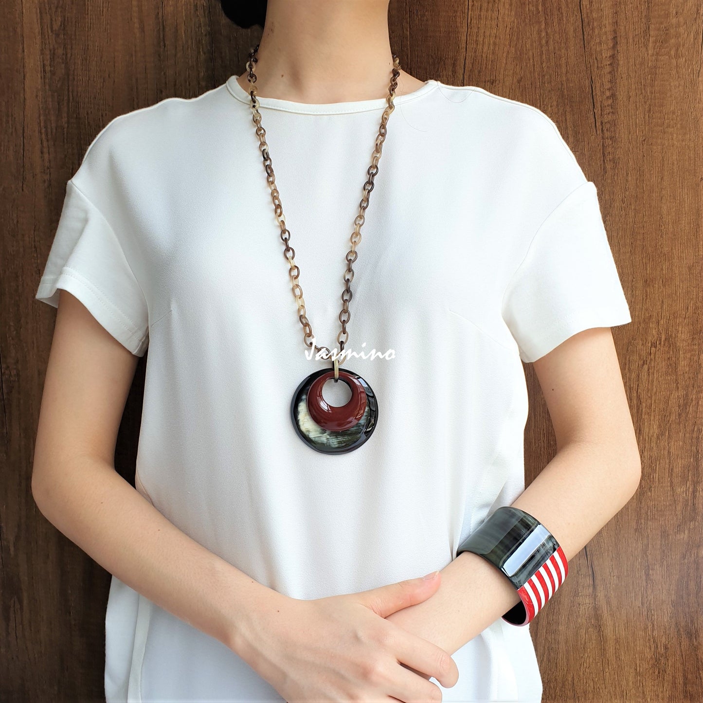 A model is wearing unique handmade double circle pendant features black and brown made of natural buffalo horn