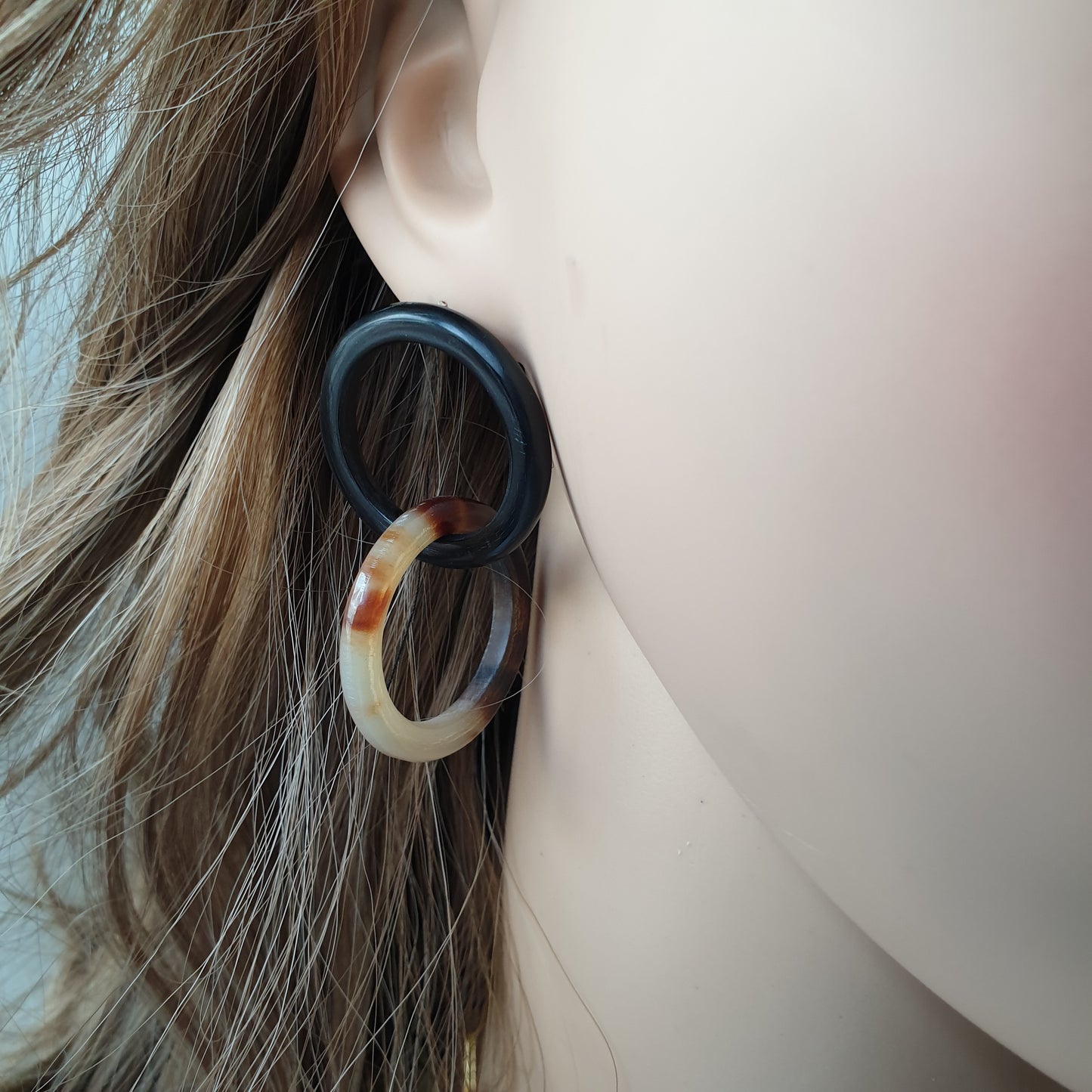 handmade earrings feature double black and brown circle in natural buffalo horn for Spring 2023 on a mannequin