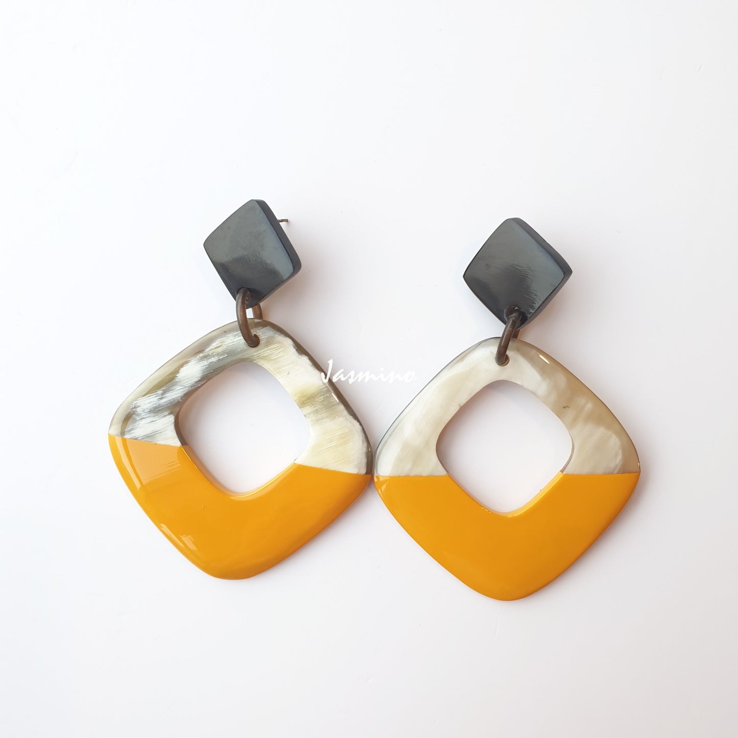 Square drop earrings feature yellow color and natural buffalo horn on a white background