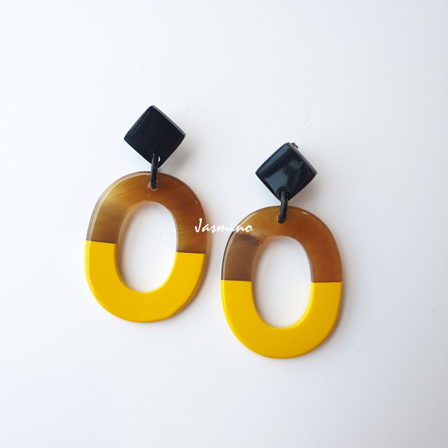 Handmade oval earrings are covered by a brown and yellow color for a unique gift