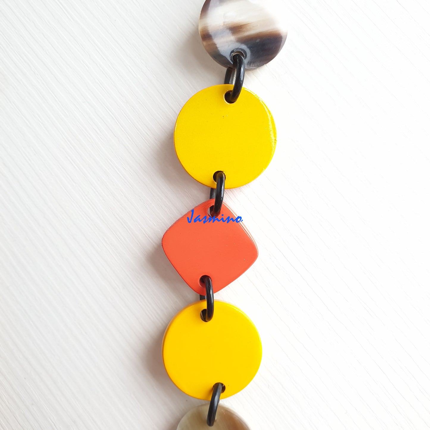 The necklace has several orange and vibrant yellow pieces combime together in natural light, impressive gift for her