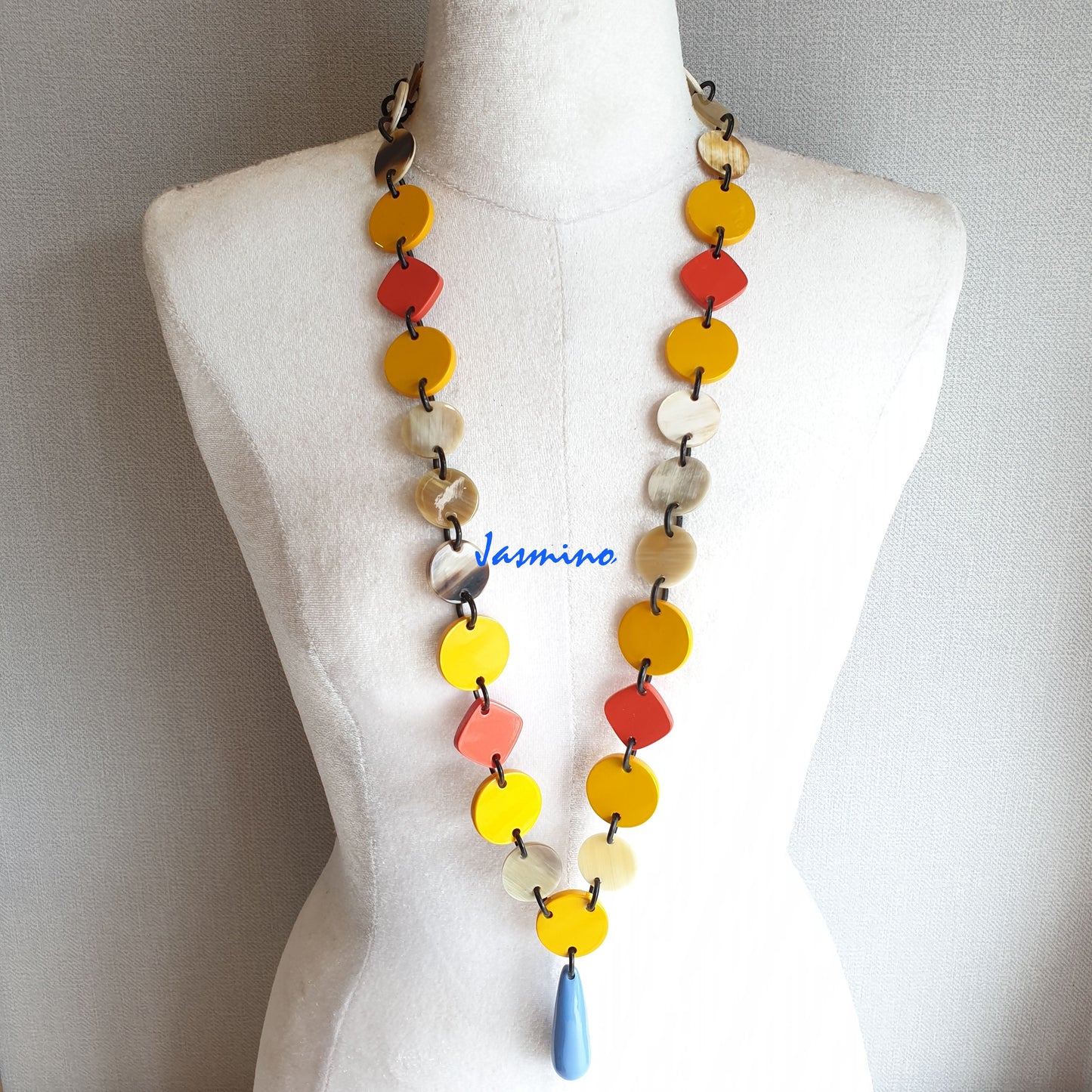 The necklace has several orange and vibrant yellow pieces combime together in natural light, impressive gift for her