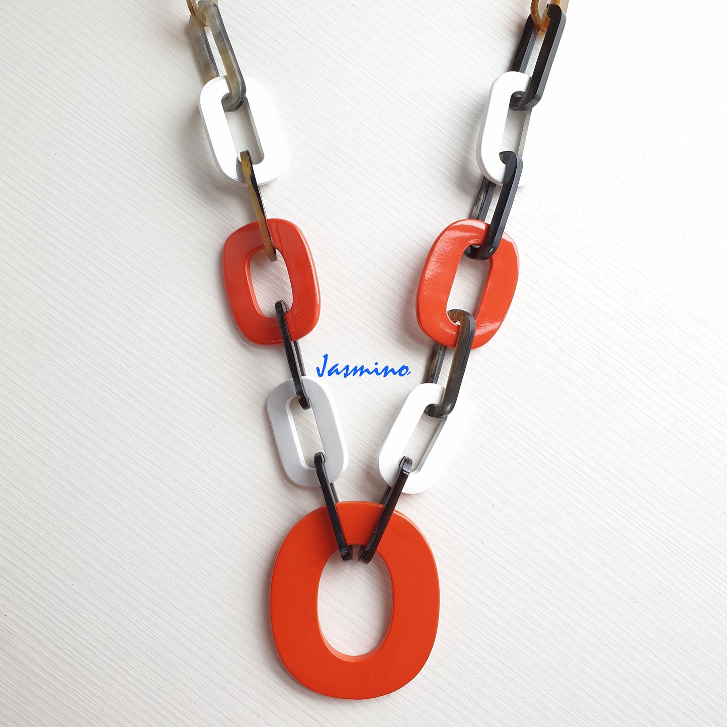 The necklace has several large orange peel and brilliant white pieces in natural light, impressive gift for her