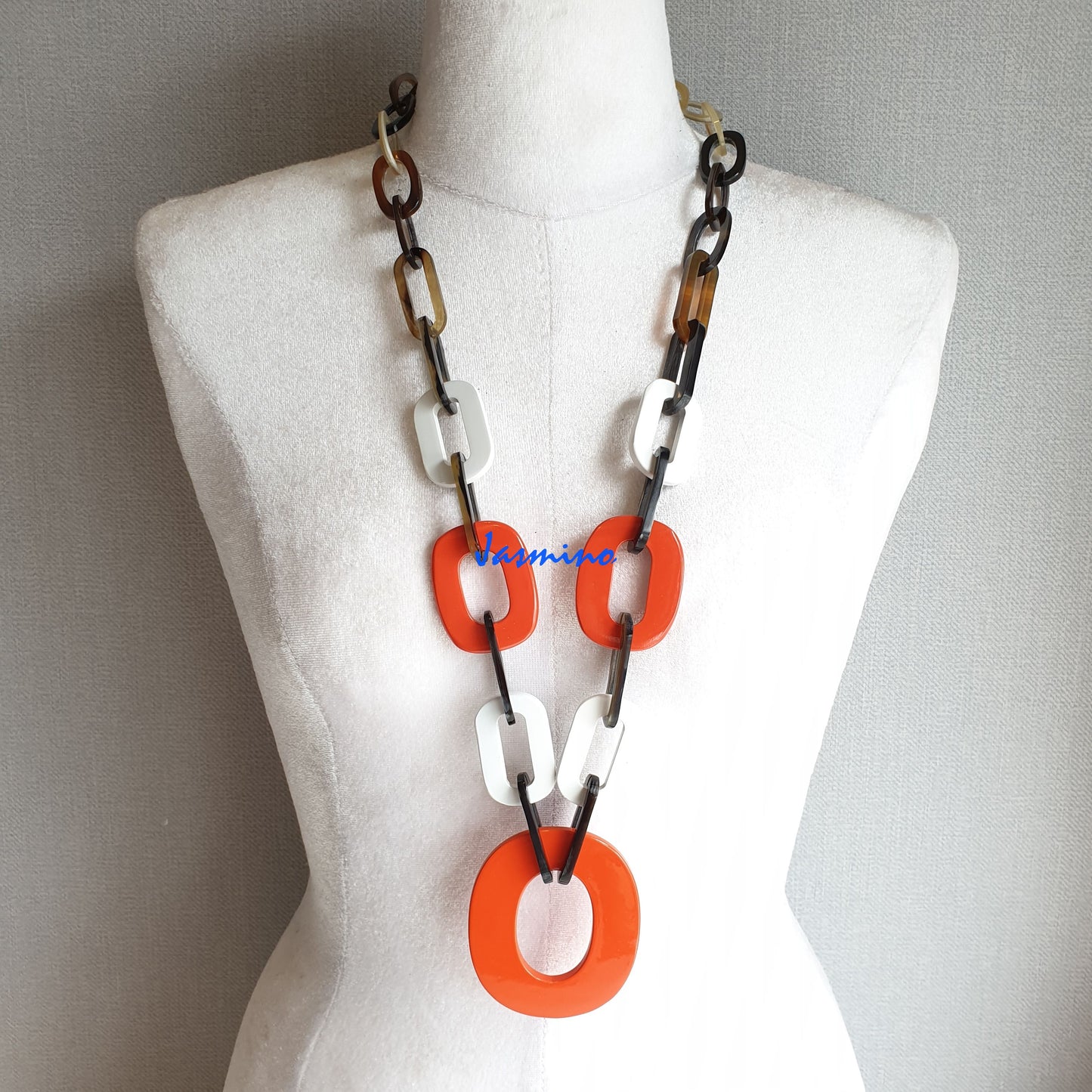 The necklace has several large orange peel and brilliant white pieces in natural light, impressive gift for her