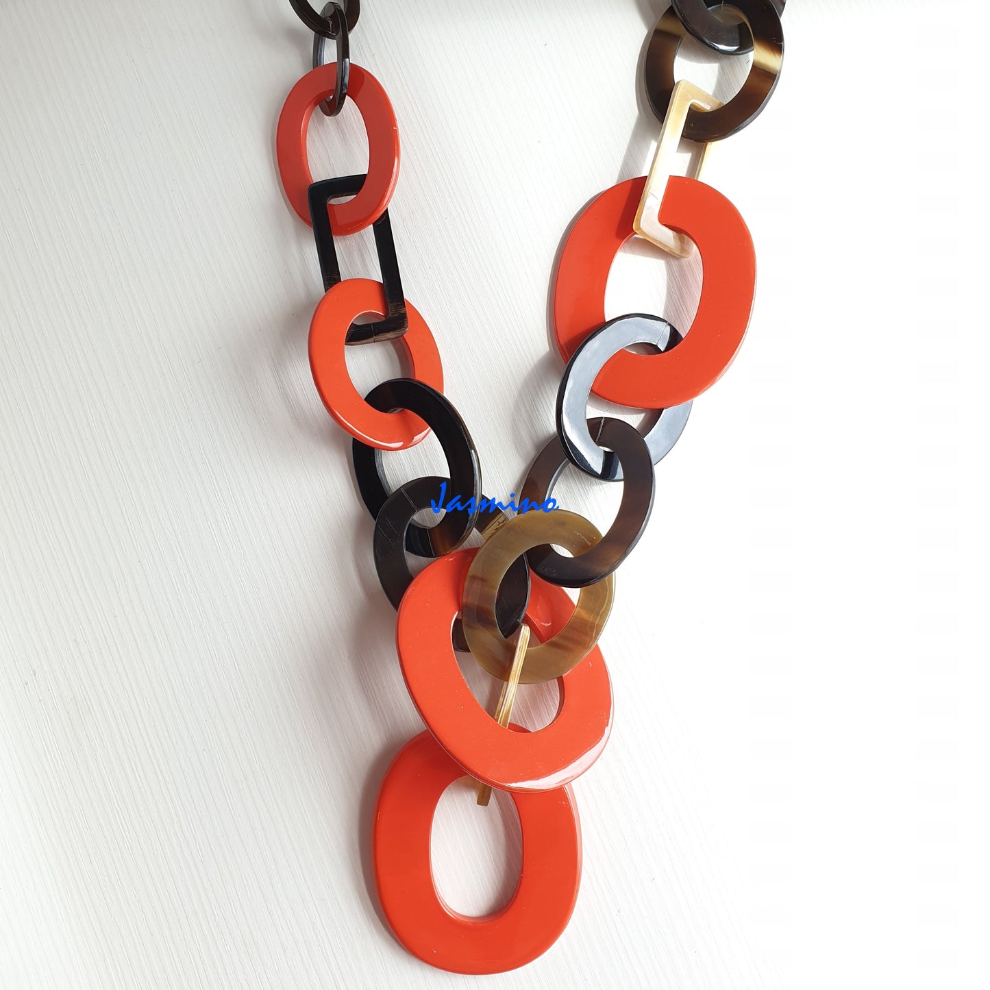 The necklace has several large orange peel pieces in natural light, impressive gift for her